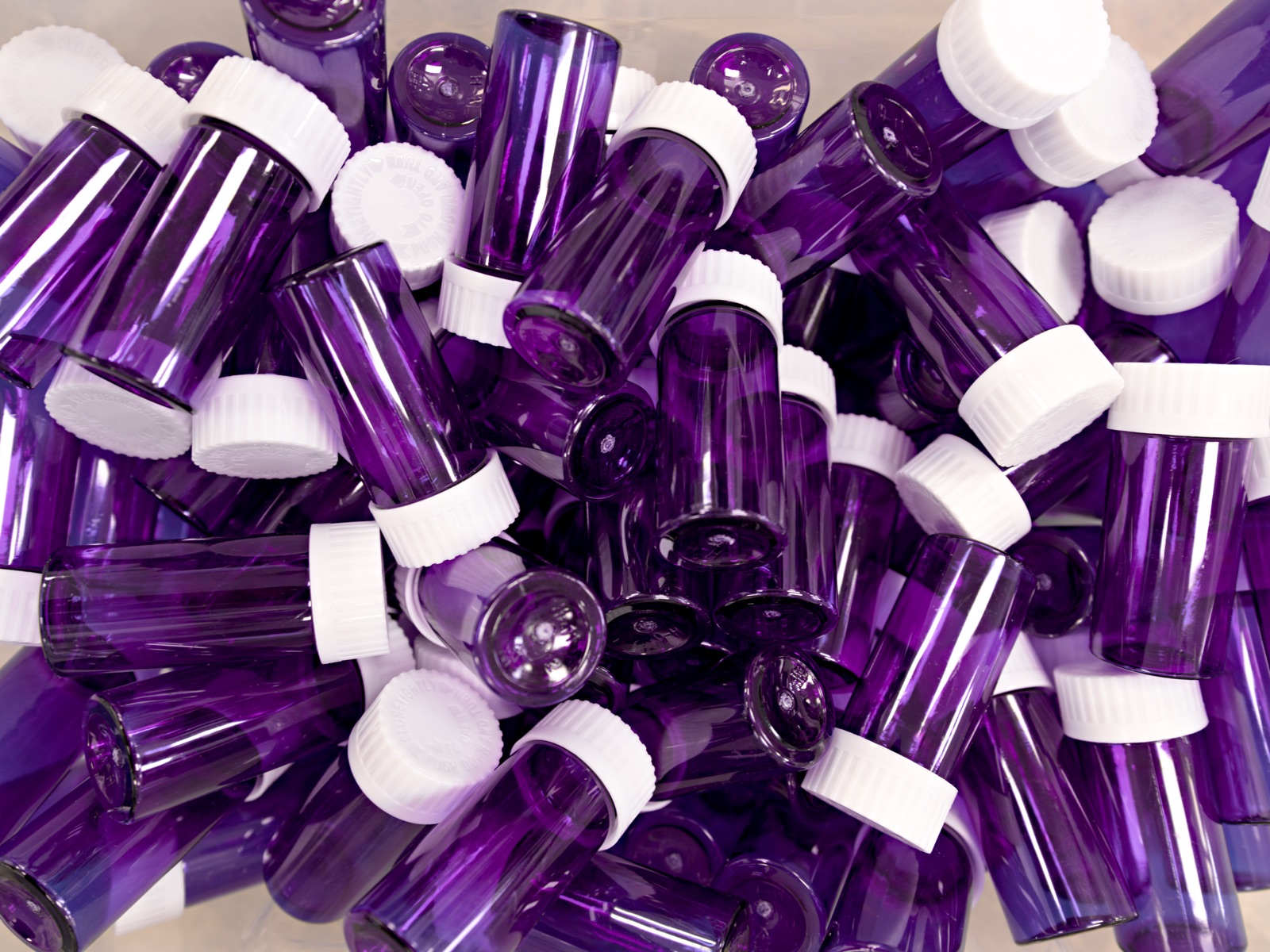 A close-up of purple and white compounded capsules